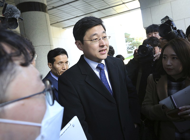 Oh Seung-hun, center, speaks to the media after a court's verdict to overturn his conviction on refusing to do mandatory military service, at the Supreme Court in Seoul, South Korea, Thursday, Nov. 1, 2018. In a landmark verdict, South Korea's top court on Thursday ruled that people can legally reject mandatory military service on conscientious or religious grounds and must not be punished. (AP Photo/Ahn Young-joon)