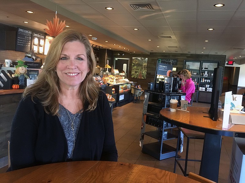 In this Wednesday, Oct. 31, 2018 photo, Jean Hoffman poses for a photo at the Starbucks in Exton, Pa. For many voters in America’s affluent suburbs, a flourishing economy is forcing a thorny dilemma for the midterm elections. Jean Hoffman, a 53-year-old real estate agent in Chester County, is pondering the college costs ahead for her two teenage daughters. She said she thinks that voting Republican might help extend the economy’s hot streak. (AP Photo/Josh Boak)