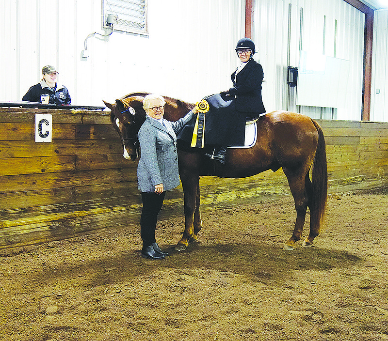 Rider Michele Smith and her horse, Romeo, complete their Century Ride on Saturday at William Woods University's fall dressage show. Judge Nena Denman, of Earlham, Iowa, presented them with their once-in-a-lifetime ribbon.