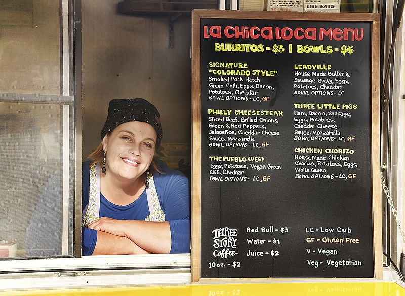 Julie Smith/News Tribune
Amanda Jensen, owner of La Chica Loca, poses in the REO Feedwagon she uses in the early morning hours to serve breakfast burritos until 10 a.m. The food trailer is located in the parking lot of The Bridge, which is off the alley way behind 619 E. High St.