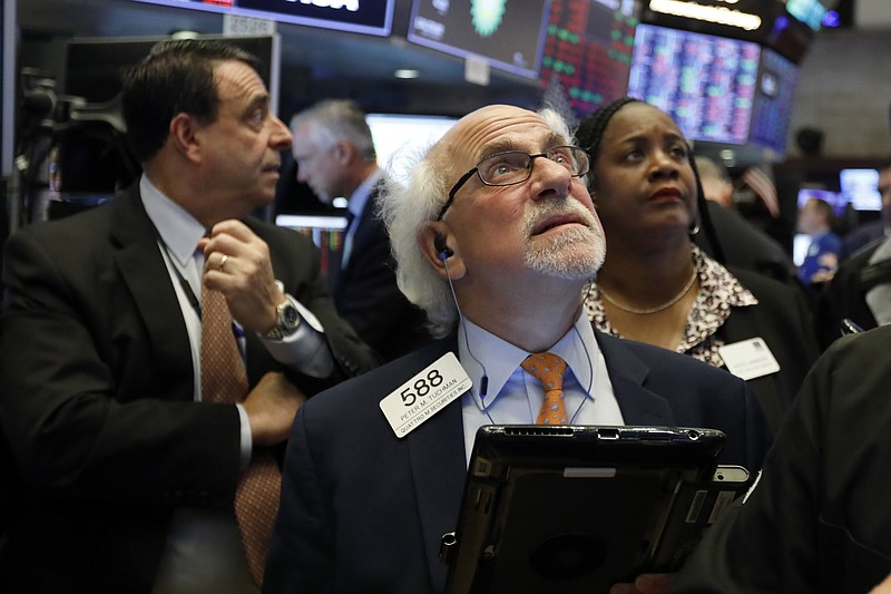 FILE - In this Tuesday, Oct. 23, 2018, file photo trader Peter Tuchman, center, works on the floor of the New York Stock Exchange. The U.S. stock market opens at 9:30 a.m. EDT on Monday, Nov. 5. (AP Photo/Richard Drew, File)
