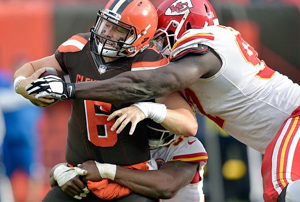 Browns quarterback Baker Mayfield is tackled by a pair of Chiefs, including defensive end Allen Bailey (right) on a failed 2-point conversion attempt during the second half of Sunday's game in Cleveland.