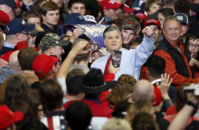 Television personality Sean Hannity points as he meets with members of the audience before the start of a campaign rally Monday, Nov. 5, 2018, in Cape Girardeau, Mo., with President Donald Trump. (AP Photo/Jeff Roberson)