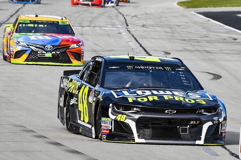 Jimmie Johnson leads Kyle Busch into Turn 1 during Sunday afternoon's NASCAR Cup Series race at Texas Motor Speedway in Fort Worth, Texas.