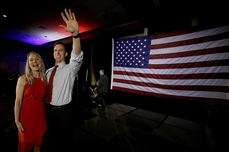 Missouri Sen.-elect Josh Hawley with his wife Erin waves to supporters after giving his victory speech at an election watch party Tuesday, Nov. 6, 2018 in Springfield, Mo. (AP Photo/Charlie Riedel)