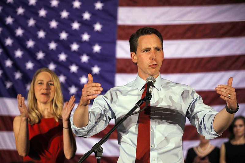 Sen.-elect Josh Hawley makes his victory speech while his wife Erin looks on during an election watch party Tuesday, Nov. 6, 2018 in Springfield, Mo. (AP Photo/Charlie Riedel)
