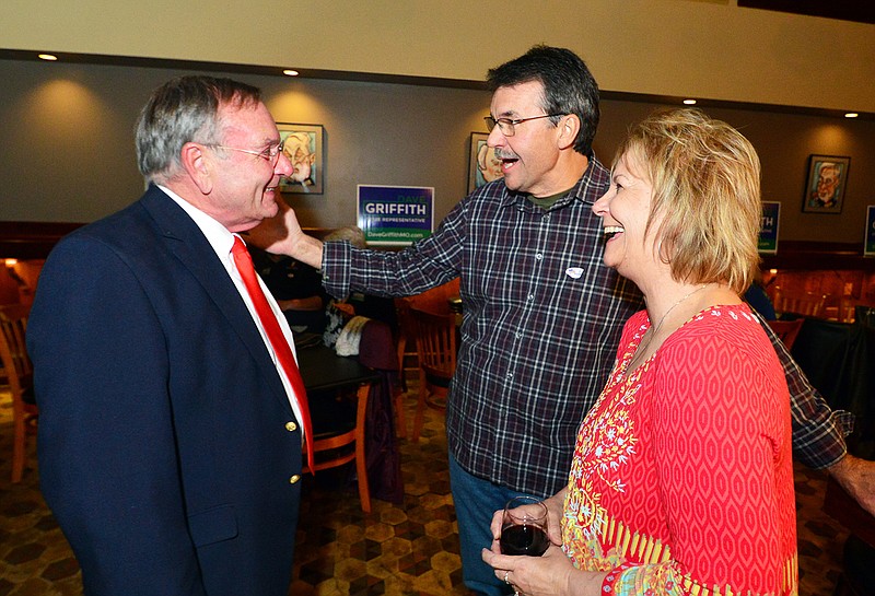 David Griffith visits with John and Loretta Schulte during a watch party Tuesday at The Side Bar at Prison Brews.