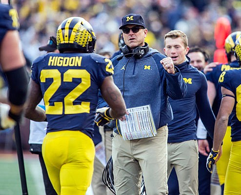 Michigan running back Karan Higdon is congratulated by head coach Jim Harbaugh after a touchdown in Saturday's game against Penn State in Ann Arbor, Mich.
