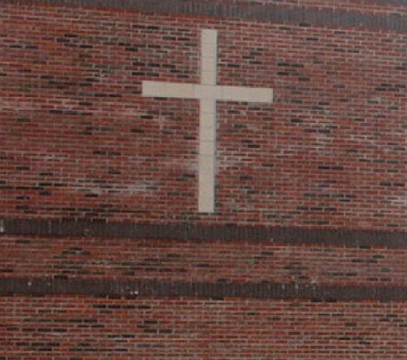 A cross graces an outside brick wall at the Crusader Athletic Complex, located across from Helias Catholic High School in Jefferson City. (News Tribune file photo)