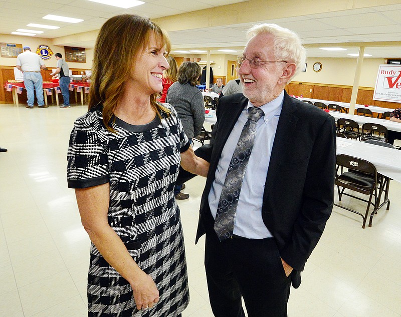 Rudy Veit visits with with his wife, Jeri, during a watch party Tuesday at the Lion's Club in Wardsville.