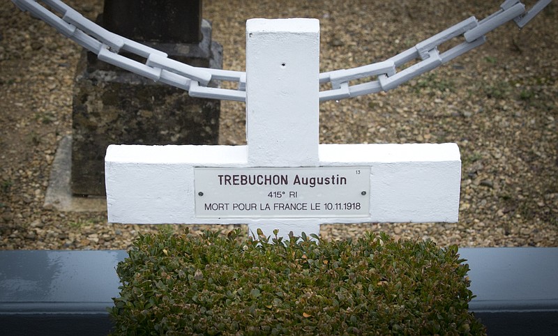 In this photo taken on Tuesday, Oct. 30, 2018, the grave marker of French WWI soldier Augustin Trebuchon in Vrigne-Meuse, France. His tiny plot is almost on the front line where the guns finally fell silent at 11 a.m. on the 11th day of the 11th month in 1918, after a four-year war that had already killed millions. Hundreds of troops died on the final morning of World War I _ even after an armistice was reached and before it came into force. Death at literally the 11th hour highlighted the futility of a conflict that had become even more incomprehensible in four years of battle. (AP Photo/Virginia Mayo)