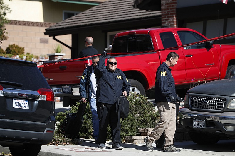 FBI agents leave the house of shooting suspect David Ian Long in Newbury Park, Calif., on Thursday, Nov. 8, 2018. Authorities said the former Marine opened fire at a country music bar in Southern California on Wednesday evening. (AP Photo/Jae C. Hong)