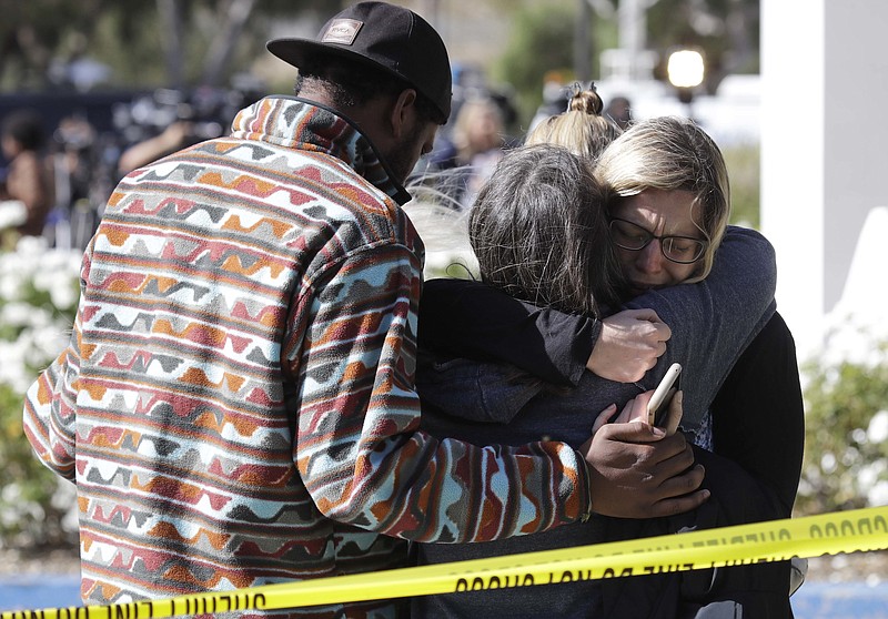 Mourners embrace outside of the Thousand Oaks Teen Center, where relatives and friends gathered in the aftermath of a mass shooting, Thursday, Nov. 8, 2018, in Thousand Oaks, Calif. Multiple people were shot and killed late Wednesday by a gunman who opened fire at the Borderline Bar & Grill, which was holding a weekly country music dance night for college students. (AP Photo/Marcio Jose Sanchez)