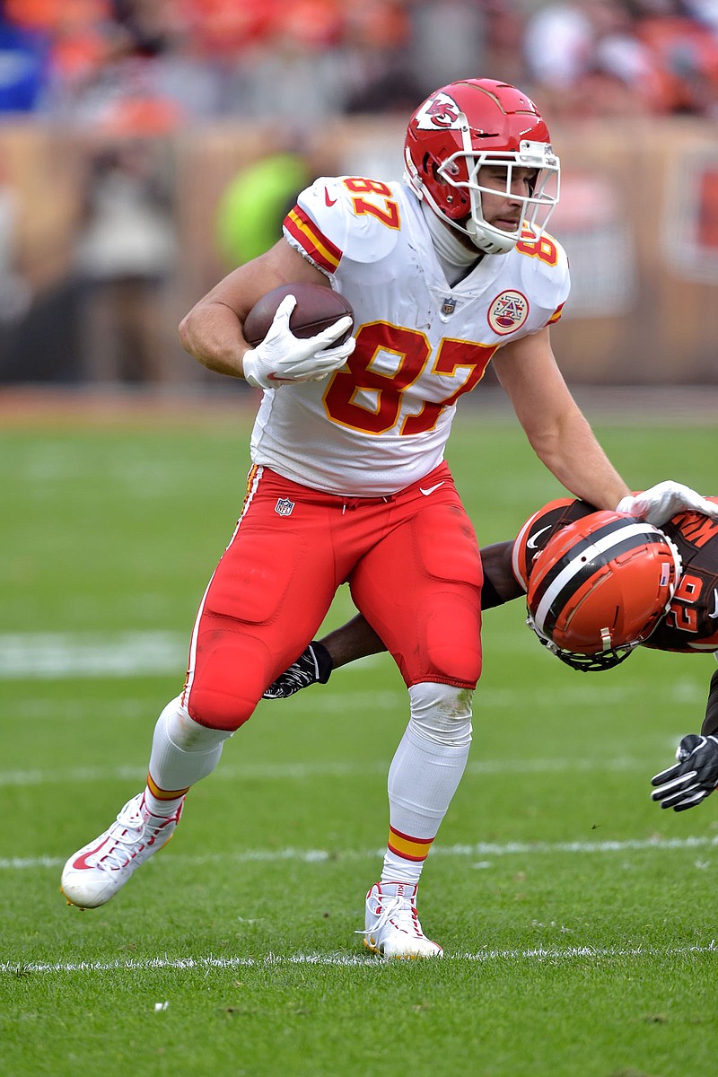 Chiefs tight end Travis Kelce shoves Browns defensive back Derrick Kindred to the ground during Sunday's game in Cleveland.