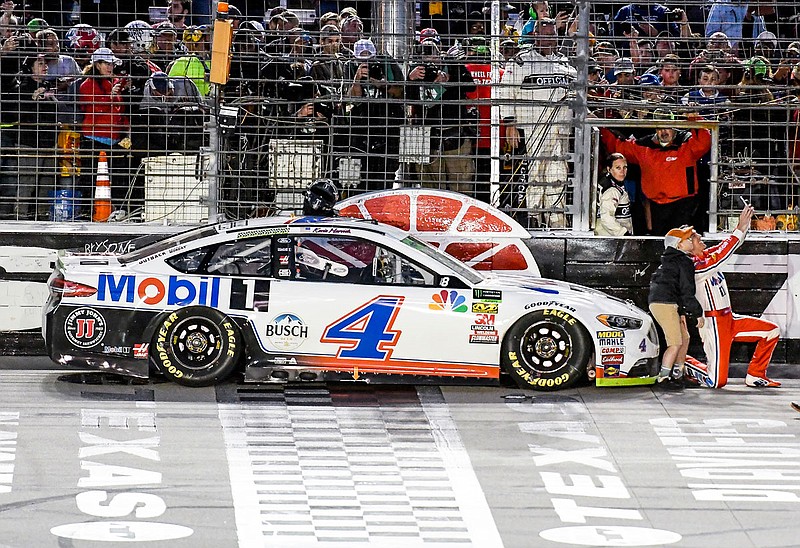 Kevin Harvick takes a photo with a young fan after winning last Sunday's NASCAR Cup Series race at Texas Motor Speedway in Fort Worth, Texas.