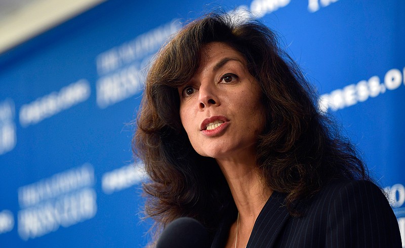 In this Sept. 21, 2018, file photo, Ashley Tabaddor, a federal immigration judge in Los Angeles and president of the National Association of Immigration Judges, speaks at the National Press Club in Washington. Tabaddor says the Trump administration's new pilot program to hold video court hearings for migrant teens instead of having them appear before a judge in person, has been riddled with glitches. (AP Photo/Susan Walsh, File)