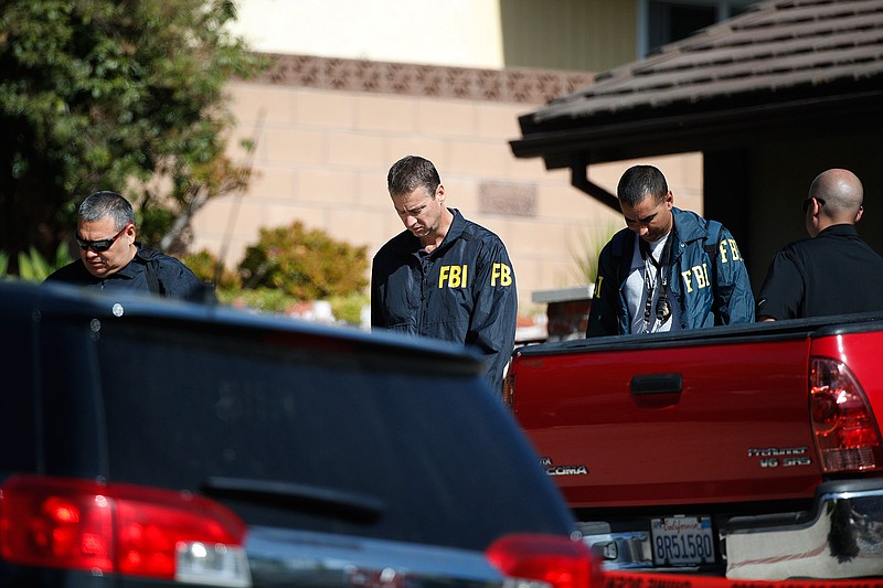 FBI agents leave the house of shooting suspect David Ian Long after conducting a search in Newbury Park, Calif., on Thursday, Nov. 8, 2018. Authorities said the former Marine opened fire at a country music bar in Southern California on Wednesday evening. (AP Photo/Jae C. Hong)