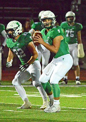 With Riley Lentz at his side, Blair Oaks quarterback Nolan Hair looks to throw during a district game against California last month in Wardsville.
