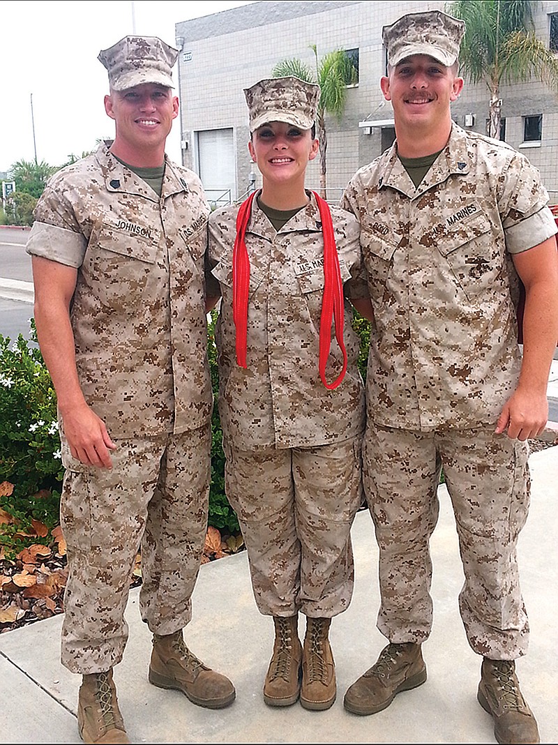 Matthew, right, and Kathryn Boyd pose with Gunnery Sergeant Derik Johnson, left, who recruited both Boyds. The red cloth strips around Kathryn's neck signify that she had just gotten promoted that day. She had just made corporal. (Submitted photo)
