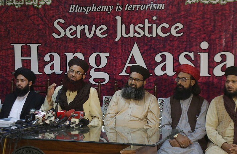 Ashraf Asim Jalali, second from left, leader of Pakistani Tehreek-e-Labbaik religious Party addresses a news conference with others regarding the acquittal of Christian woman Asia Bibi, in Lahore, Pakistan, Thursday, Nov. 8, 2018. A Christian woman acquitted after eight years on death row in Pakistan for blasphemy was released but her whereabouts in Islamabad on Thursday remained a closely guarded secret in the wake of demands by radical Islamists that she be publicly executed. (AP Photo/K.M. Chaudary)