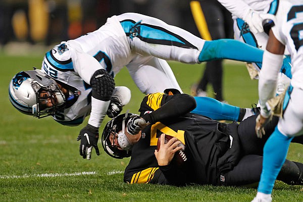 Steelers quarterback Ben Roethlisberger is hit by Panthers strong safety Eric Reid as he slides at the end of a run during the second half of Thursday night's game in Pittsburgh.
