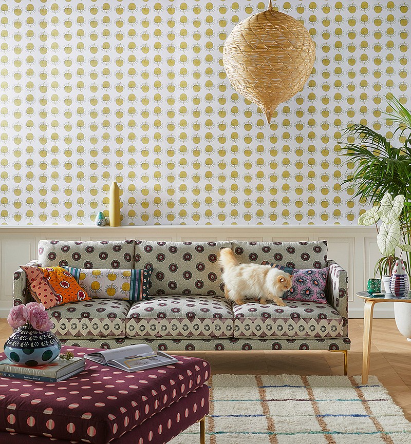 This undated photo provided by Anthropologie shows the Linde sofa, a collaborative collection with luxury lifestyle brand SUNO. Featuring a geometric print and cast iron legs, the sofa has a chic yet relaxed midmod Italian profile. (Anthropologie via AP)