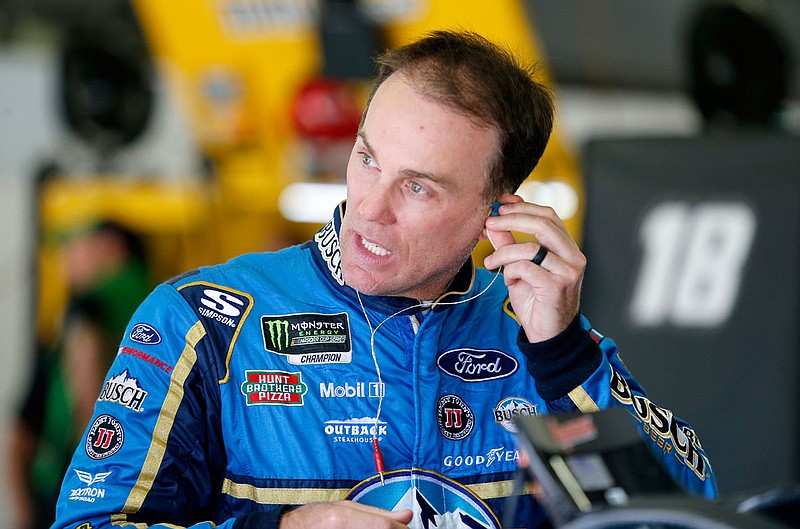 In this July 21 file photo, Kevin Harvick puts in an ear piece as he prepares for practice at New Hampshire Motor Speedway in Loudon, N.H. 