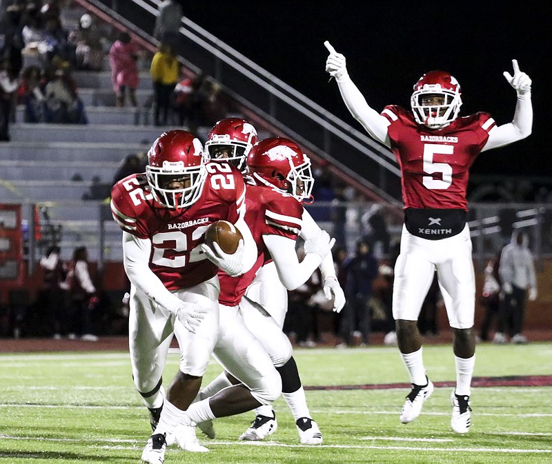 Arkansas High defensive back Tyrie Black runs a fumble recovery toward the end zone while being cheered on by teammate Dejordan Mask during the Razorbacks' game against the Nettleton Raiders on Friday at Razorback Stadium.