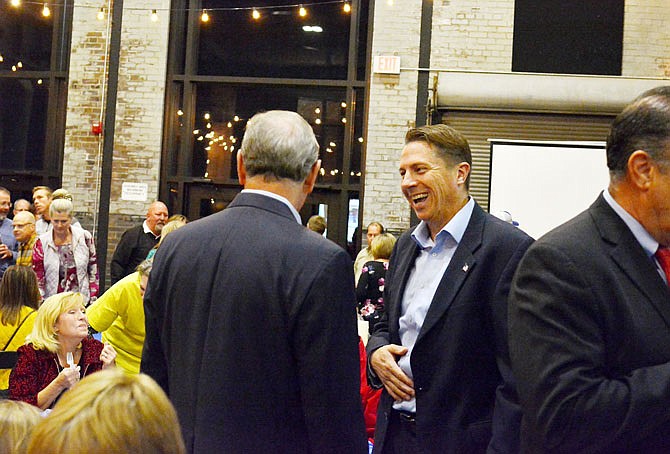 Republican candidate for Cole County Associate Circuit Judge Cotton Walker, right, laughs with congressman Blaine Luetkemeyer, center, Tuesday during the Cole County Republican Election Night Watch Party at The Millbottom.