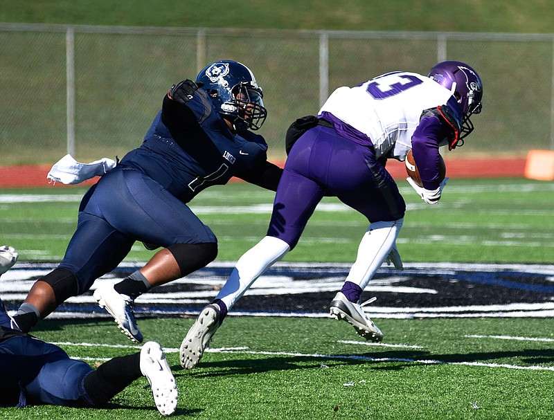 Lincoln linebacker Amani Nelson reaches for McKendree wide receiver Coree Harrell during Saturday's game at Dwight T. Reed Stadium.