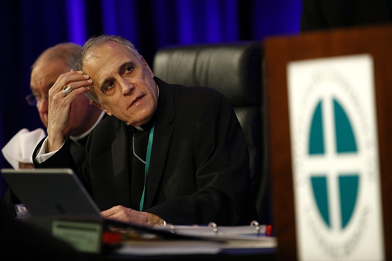 Cardinal Daniel DiNardo of the Archdiocese of Galveston-Houston, president of the United States Conference of Catholic Bishops, prepares to lead the USCCB's annual fall meeting, Monday, Nov. 12, 2018, in Baltimore. (AP Photo/Patrick Semansky)