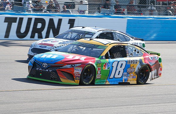 Kyle Busch (18) leads Brad Keselowski on lap 120 during Sunday's NASCAR Cup Series race in Avondale, Ariz.