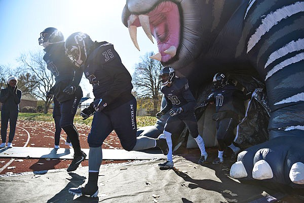 From left, Lincoln's Justin Korakakos, Daveon Adams, Eric Brice and Tylan Oglesby lead the Blue Tigers onto the field before Saturday's kickoff against McKendree at Dwight T. Reed Stadium. Lincoln lost 50-32 to the Bearcats in the regular-season finale.