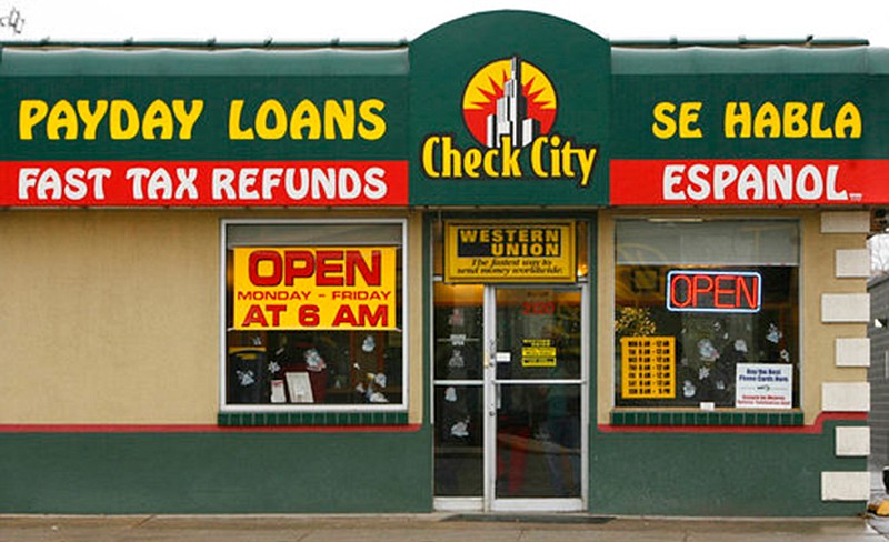 This undated photo shows a sign for Check City, which offers payday loans, in Salt Lake City. Americans take out roughly $50 billion in payday loans a year, each racking up hundreds of dollars in fees and interest.