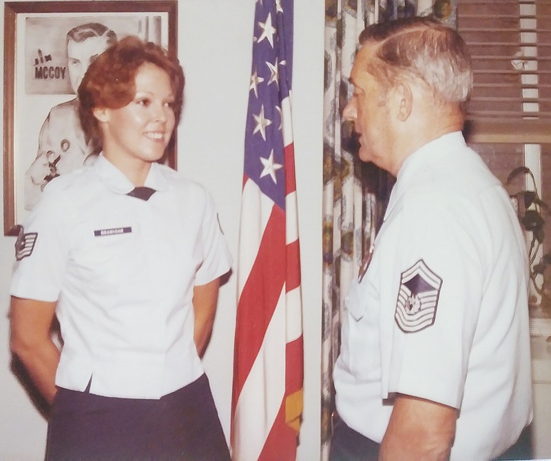 Hill is pictured while on temporary duty at the Pentagon in the early 1980s. She is visiting with James M. McCoy, who was chief master sergeant of the Air Force.