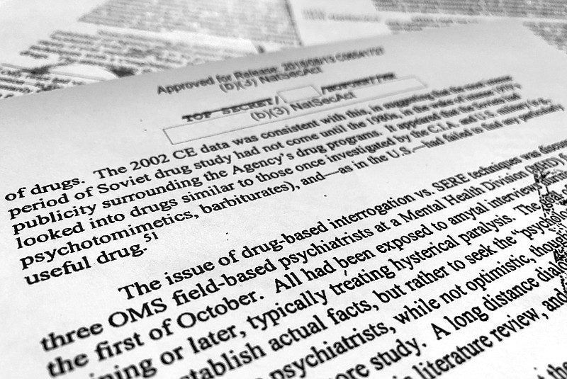 A portion of a once-classified CIA report that disclosed the existence of a drug research program dubbed "Project Medication" is photographed in Washington, Tuesday, Nov. 13, 2018. Shortly after 9/11, the CIA considered using a drug that might work like a truth serum and force terror suspects to give up information about potential attacks. After months of research, the agency decided that a drug called Versed, a sedative often prescribed to reduce anxiety, was “possibly worth a try.” But in the end, the CIA decided not to ask government lawyers to approve its use. The American Civil Liberties Union fought in court to have the report released.  (AP Photo/Jon Elswick