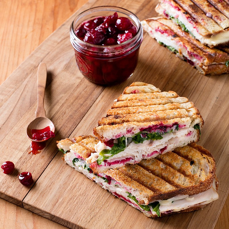 This undated photo provided by America's Test Kitchen in October 2018 shows smoked turkey panini with simple cranberry sauce in Brookline, Mass. This recipe appears in the cookbook "Just Add Sauce." (Steve Klise/America's Test Kitchen via AP)
