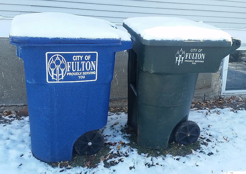 <p>Photo by Jenny Watson/FULTON SUN</p><p>Familiar blue and green bins are shown in a Fulton yard, one for recycling and the other for normal garbage. Recycling costs are driving city officials to discuss options.</p>