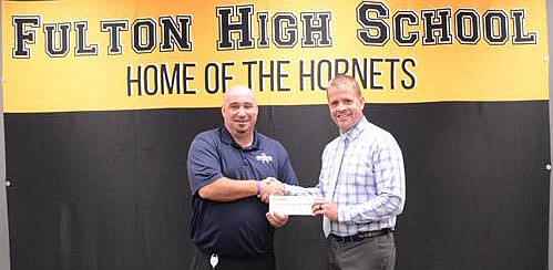 <p>Submitted</p><p>Fulton HS principal Chris Mincher receives $10,000 check Tuesday from Steve Gibson, Dollar General’s Fulton distribution center director.</p>