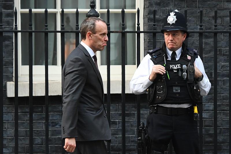 Britain's Secretary of State for Exiting the European Union Dominic Raab, leaves after a cabinet meeting at 10 Downing Street in London, Tuesday, Nov. 13, 2018. Negotiators from Britain and the European Union have struck a proposed divorce deal that will be presented to politicians on both sides for approval, officials in London and Brussels said Tuesday. (Victoria Jones/PA via AP)