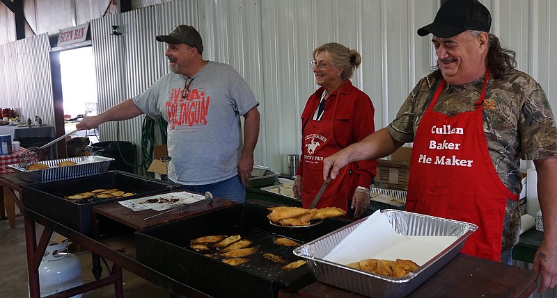 Frying 1,488 pies as ordered and sold at the Cullen Baker Fair in Bloomburg, Texas, are cooks, from left, Staley Cash, Mayor Deloris Simmons and Henry Hodges.
