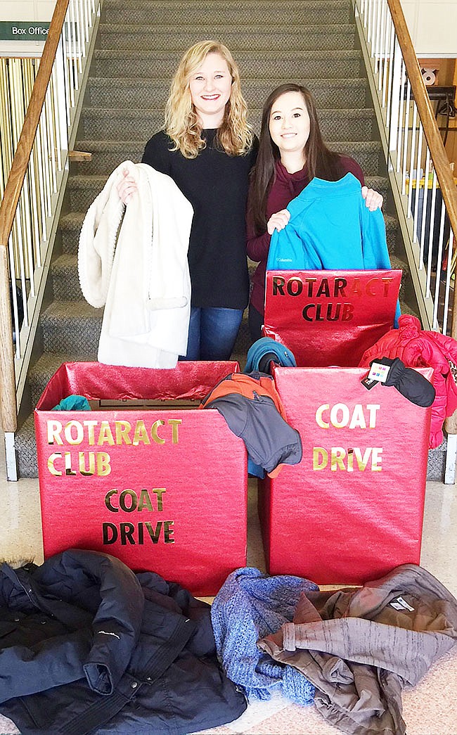 Baylie Borman, left, and Ida Jacaway of the William Woods University Rotaract Club sort coats collected during the 2017 drive. 