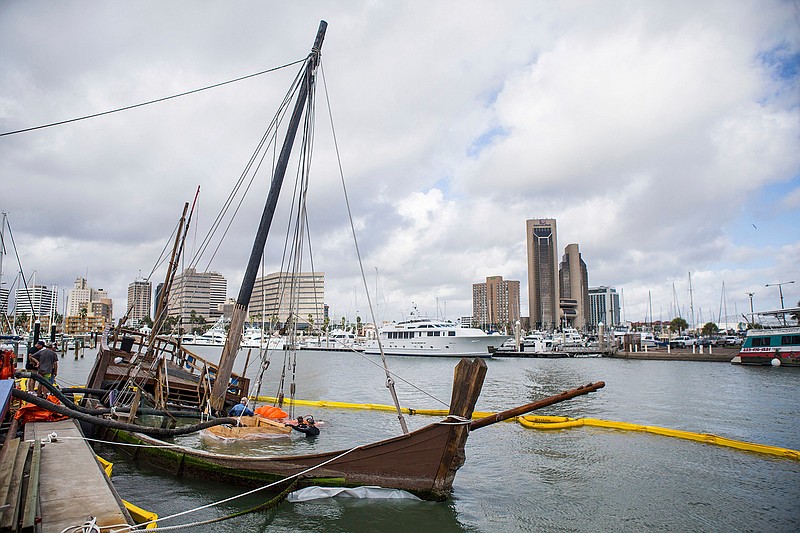 In this Oct. 4, 2017, file photo photo, crews prepare the La Nina before raising it from the bottom of the bay at Lawrence Street T-head in Corpus Christi, Texas. The replica Columbus ship sank when Hurricane Harvey struck Corpus Christi in late August 2017. Corpus Christi officials on Tuesday, Nov. 13, 2018, announced a Feb. 22, 2019, deadline for groups interested in saving La Nina. Previous deadline was Sept. 28. (Casey Jackson /Corpus Christi Caller-Times via AP, File)