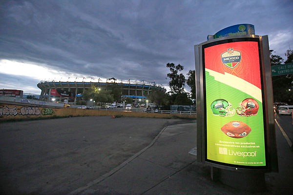 Department store advertising featuring NFL logos stands outside a dark Azteca Stadium on Tuesday in Mexico City. The NFL has moved the Chiefs' Monday night showdown with the Rams from Mexico City to Los Angeles due to poor field conditions at Azteca Stadium.