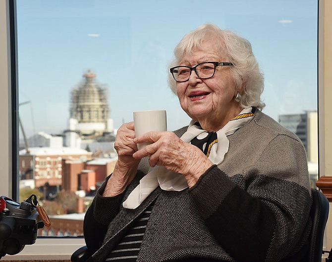 Jimmie Dean "Honey" Charton enjoys a cup of coffee Thursday in front of the window at Sapphires Restaurant so she can see Ceres come down from her perch atop the Capitol.