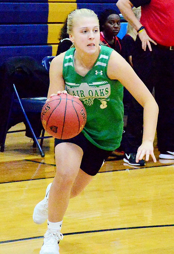 Bailey Rissmiller of Blair Oaks dribbles the ball along the baseline against Jefferson City during Thursday night's Helias Jamboree at the Helias Auxiliary Gym.