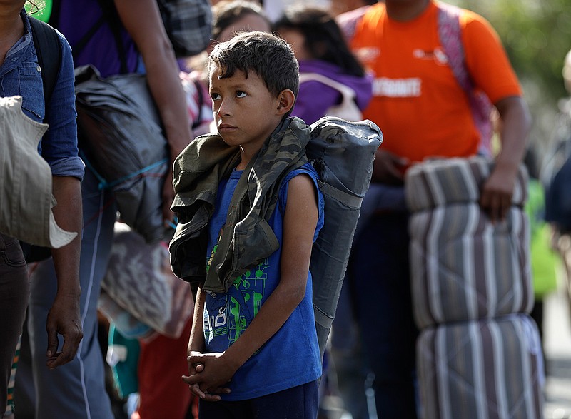 Young Honduran migrant Daniel Gamez waits with his family in a line for a meal after arriving with the Central America migrant caravan in Tijuana, Mexico, Thursday, Nov. 15, 2018. Members of a migrant caravan started to meet some local resistance as they continued to arrive by the hundreds in the Mexican border city of Tijuana, where a group of residents clashed with migrants camped out by the U.S. border fence. (AP Photo/Gregory Bull)