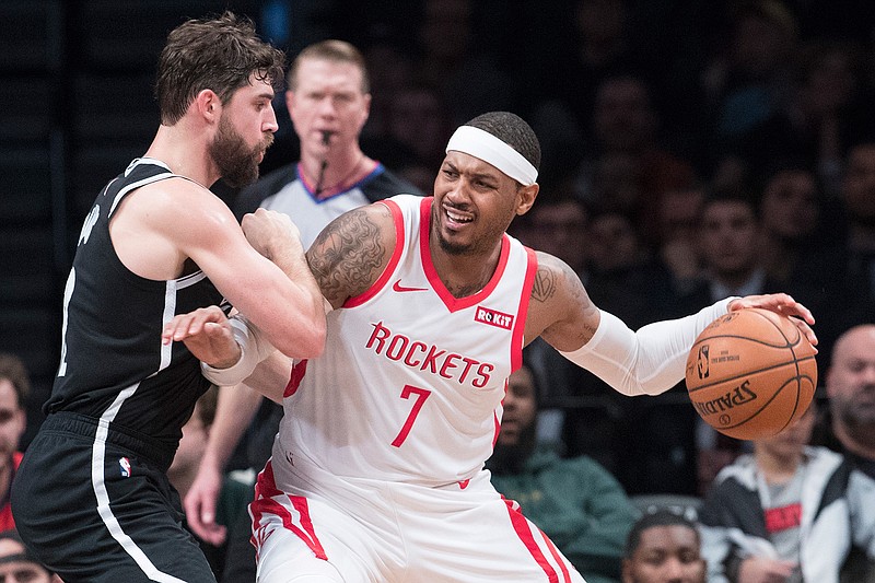 In this Friday, Nov. 2, 2018 file photo, Brooklyn Nets forward Joe Harris guards Houston Rockets forward Carmelo Anthony (7) during the second half of an NBA basketball game in New York. Carmelo Anthony is done in Houston. Rockets general manager Daryl Morey released a statement Thursday, Nov. 15, 2018 saying the team is "parting ways" with Anthony and "working toward a resolution." (AP Photo/Mary Altaffer, File)