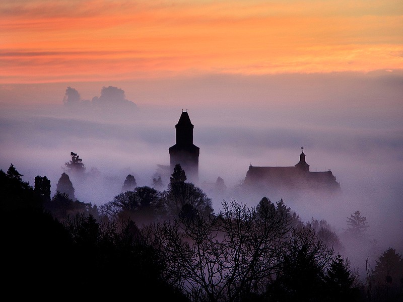 The castle of Kronberg looks out of the fog that covers the city of Frankfurt, Germany, Wednesday, Nov. 14, 2018. (AP Photo/Michael Probst)