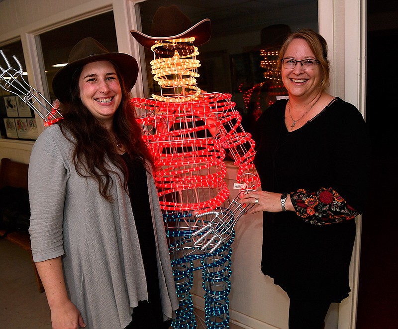 Luci Wedeking, left, the Cowboy Country Museum director and curator Jewellee Kuenstler stand beside "Windy Bill" at the museum's entrance Wednesday Oct. 31, 2018 in Stamford, Texas. (Ronald W. Erdrich/The Abilene Reporter-News via AP)